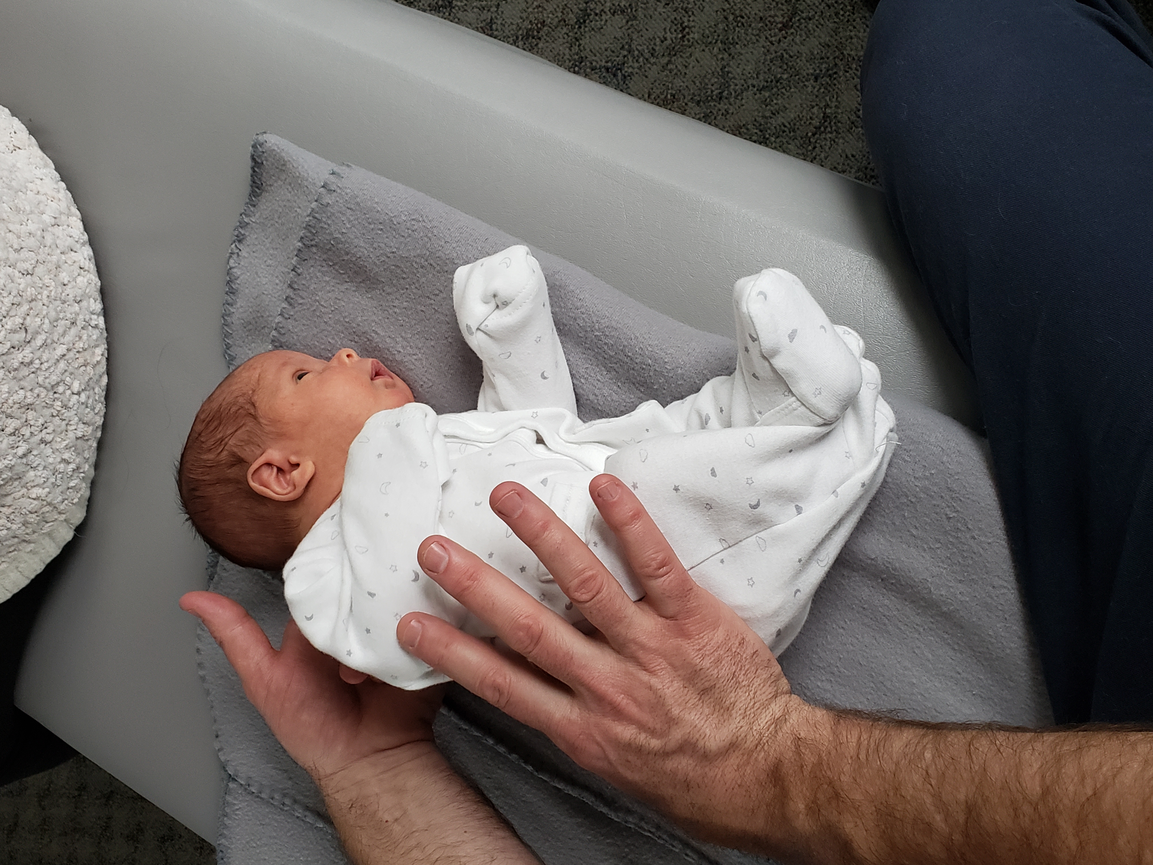 Dr. Steve gently adjusting a newborn baby