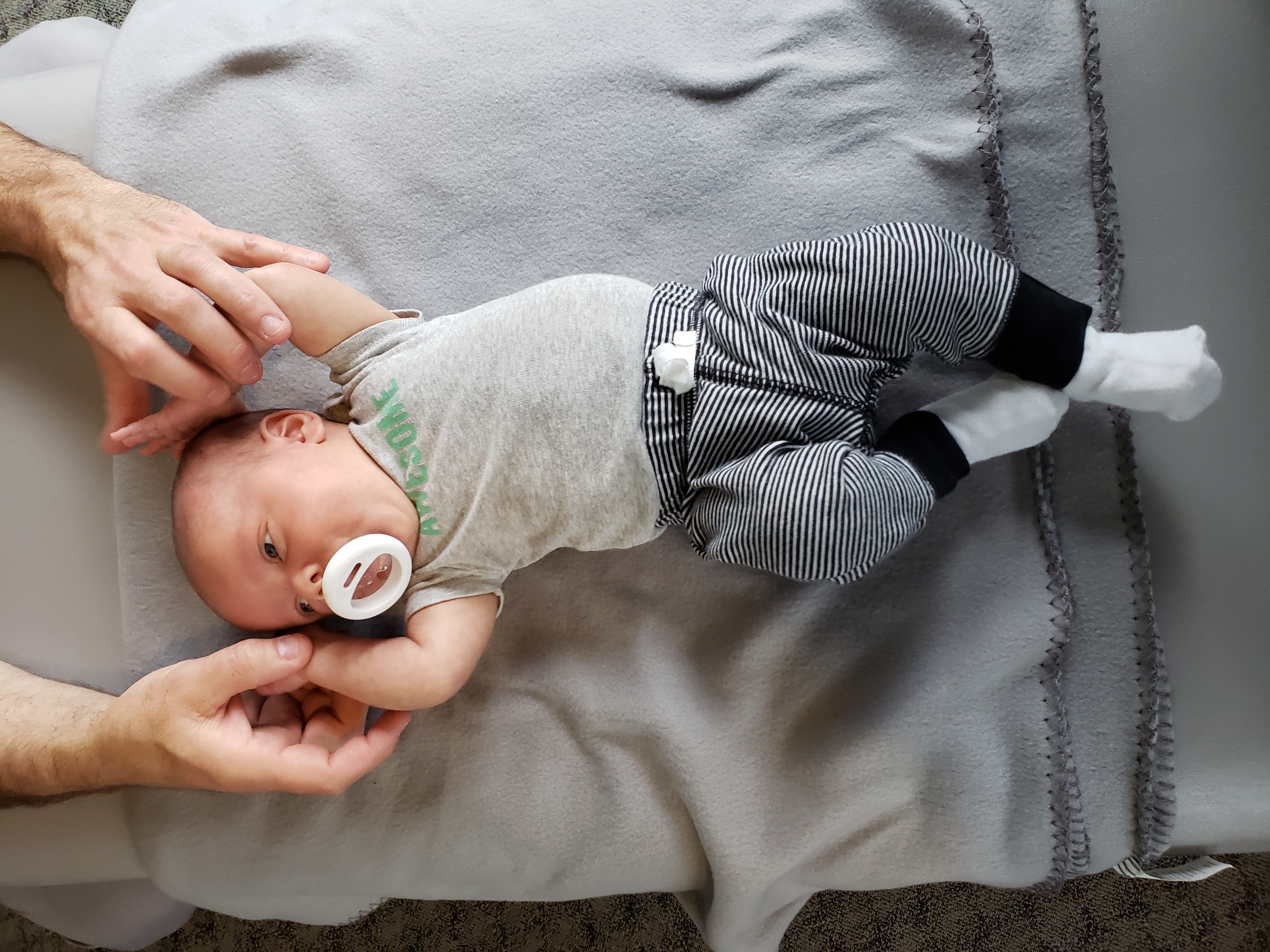 Dr. Steve supporting a young infant during a chiropractic visit