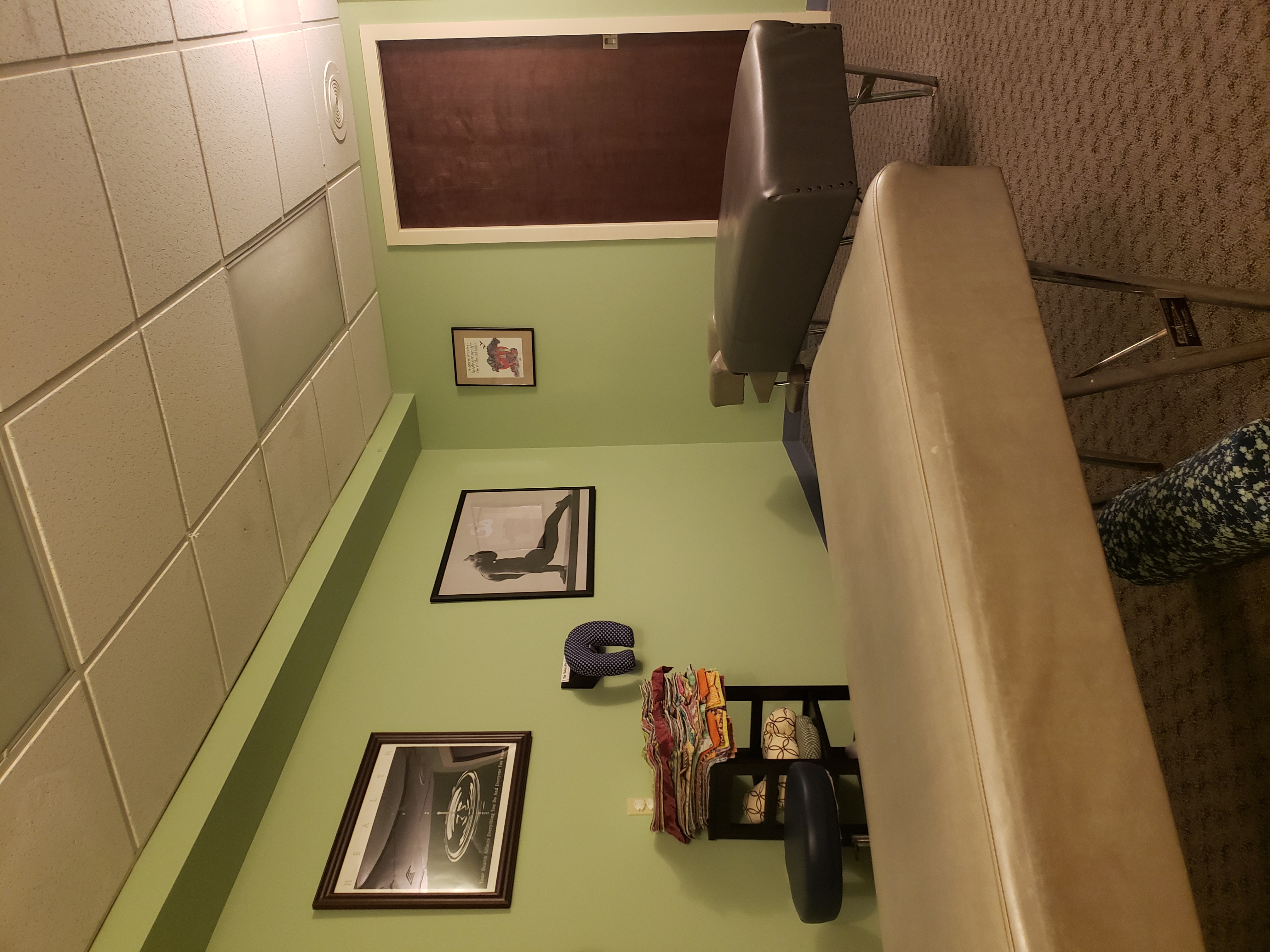 Treatment room with adjusting table and framed artwork