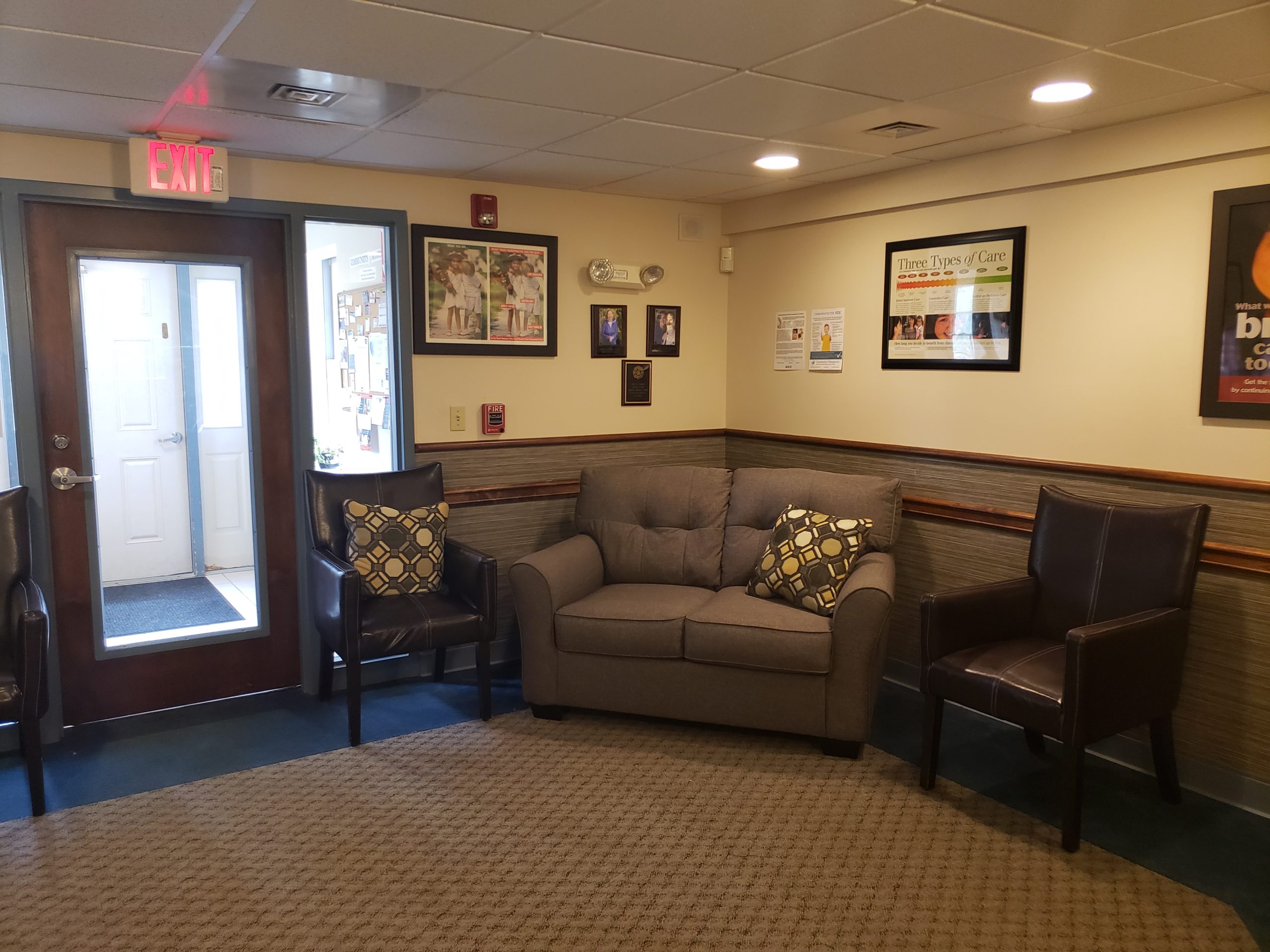 Community Chiropractic waiting room with sofa and chairs