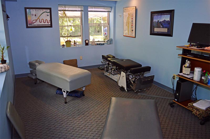 Spacious chiropractic adjusting room with multiple tables at Community Chiropractic