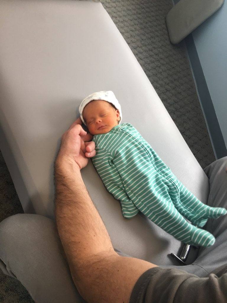 Dr. Steve gently adjusting a newborn baby
